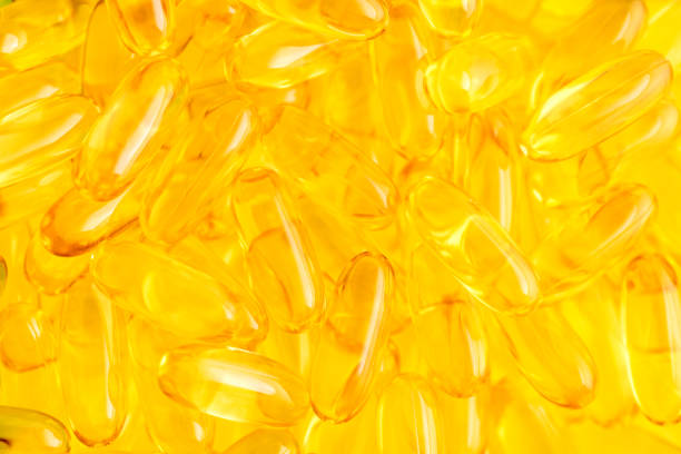 istock Fish oil Omega 3 abstract yellow background 1336462100
