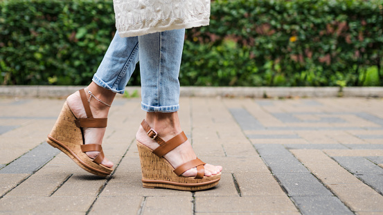 Women's legs in jeans and platform shoes