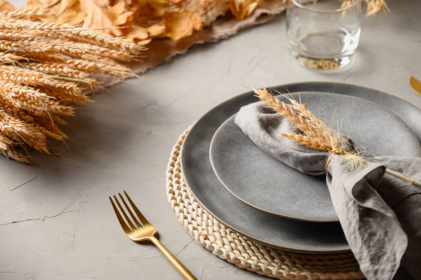 istock Halloween and Thanksgiving day table setting with gray plate decorated fallen leaves,natural materials. 1336462268