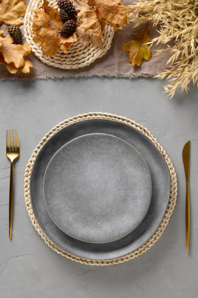 istock Halloween and Thanksgiving day table setting with gray plate decorated fallen leaves,natural materials on gray table. 1336462273