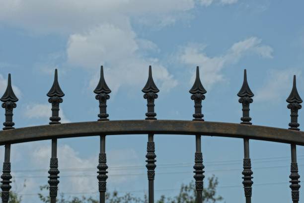 istock a row  iron sharp rods on a black  wall of a metal fence 1336462329