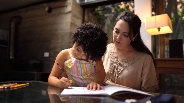 istock Mother helping daughter with homework 1336462515