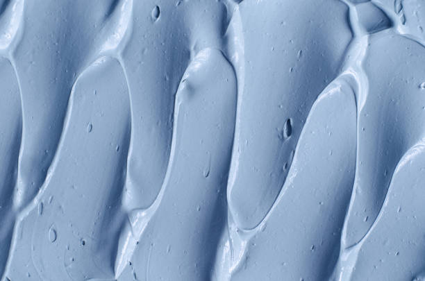 istock Light blue bentonite facial clay (alginate mask, face cream, body wrap) texture close up, selective focus. Abstract background with brush strokes. 1336463318