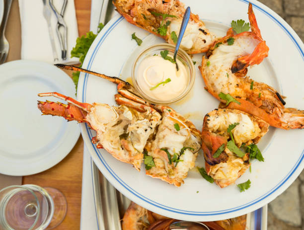 Grilled lobster and tiger shrimp ready to eat Grilled lobster and tiger shrimp ready to eat. Portuguese plate of grilled lobster and tiger shrimp served with mayonnaise and parsley. black tiger shrimp stock pictures, royalty-free photos & images