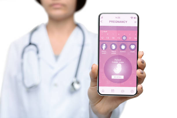istock Young doctor showing mobile application for pregnancy 1336464488