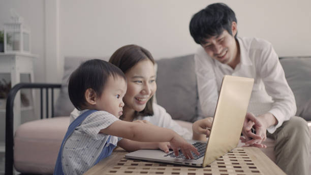 istock Son looking at laptop with their parents 1336464733
