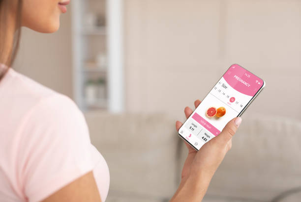 istock Young pregnant woman using mobile application for pregnancy 1336464778