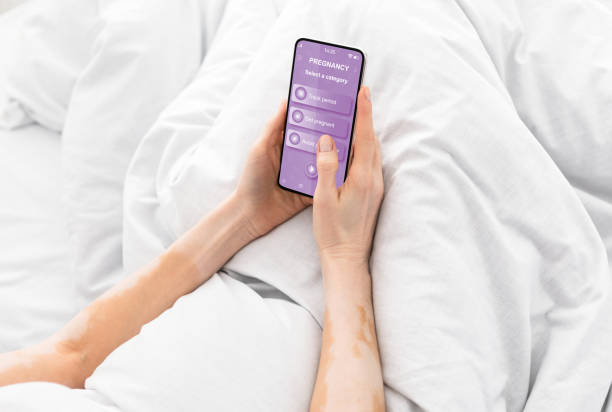 istock Pregnant woman showing mobile application for pregnancy 1336464905