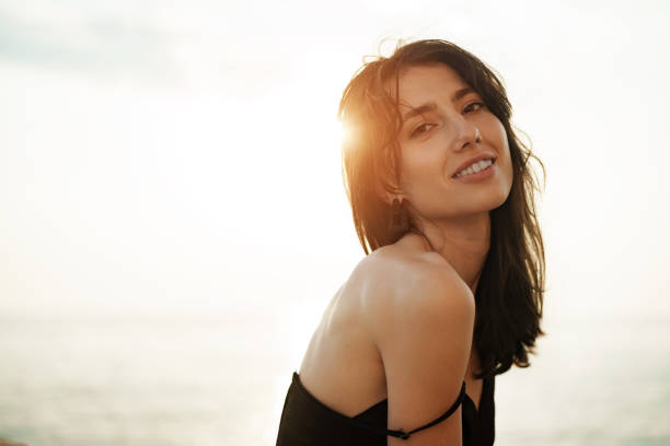 istock Young smiling woman outdoors portrait at beach 1336468637