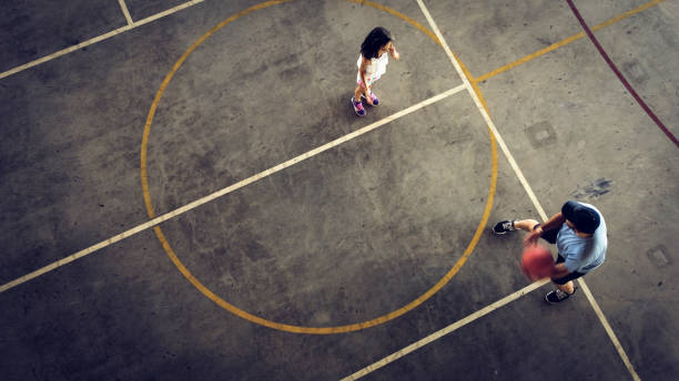 istock Father and daughter playing basketball 1336469013