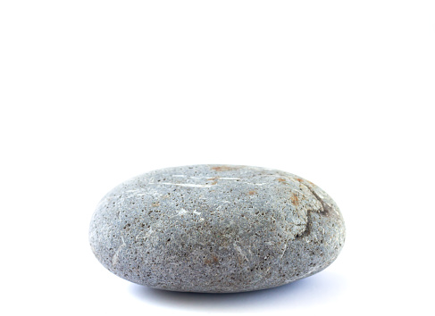 Grey stone isolated on white. Focus is front to back.