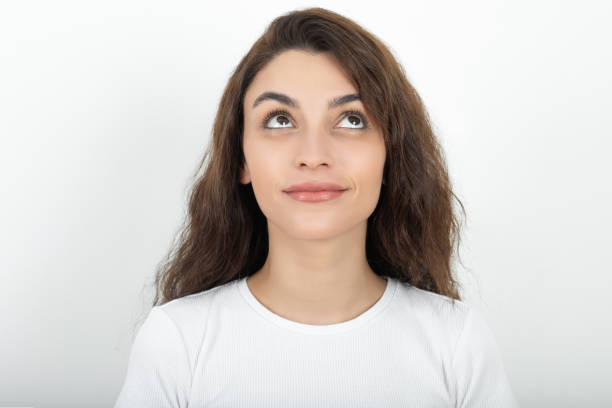 istock Happy young woman with smile looking up 1336472445