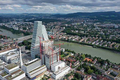 Headquarters of the  Swiss multinational healthcare company Roche. Roche Holding was founded in 1896. The Company has arround 94,000 employees (2017). The image shows the Roche headqurters with the Tower 1(178m) and Tower 2(205m) and several other buildings under construction