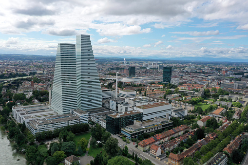 Basel City panoramic wiev over the districts located at the right side of the Rhine river including several modern skyscrapers. The high angle image was captured during summer season.