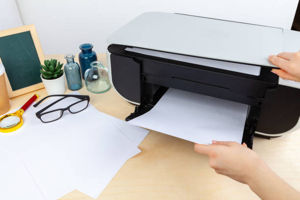 istock Hands of a woman using a copying machine close up 1336474396