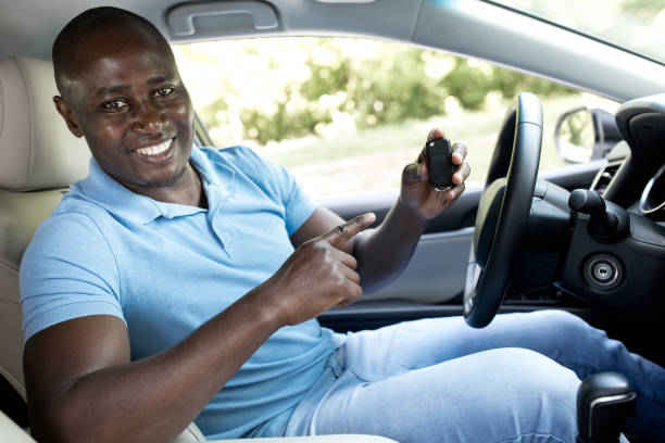 istock Happy black man showing key from his new car 1336475549