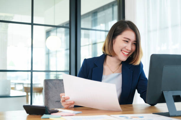 istock Business woman busy working on laptop computer at office. 1336475602