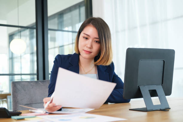 istock Business woman busy working on laptop computer at office. 1336475603