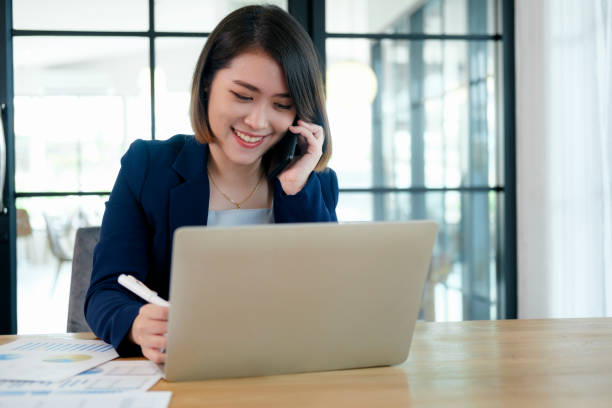 istock Business woman busy working on laptop computer at office. 1336475605