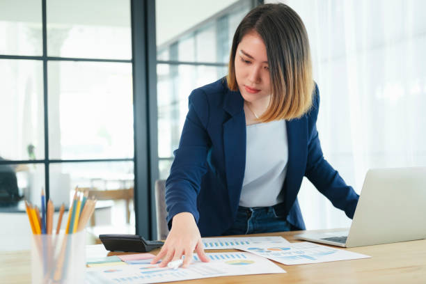 istock Business woman busy working on laptop computer at office. 1336475606