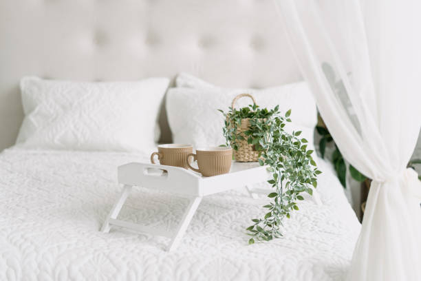 istock White bedroom interior, closeup at bed with tray. 1336478222