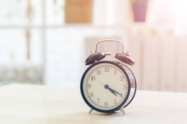 istock Morning sun. Alarm clock on a beautiful background 1336478334
