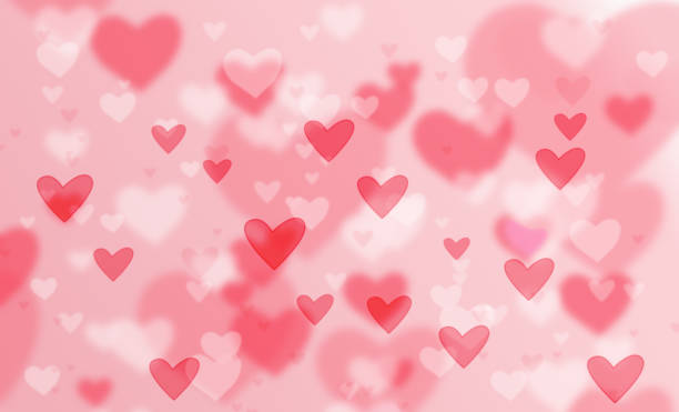 istock Defocused lights on a red background in the shape of hearts. A festive abstract background. 1336479788