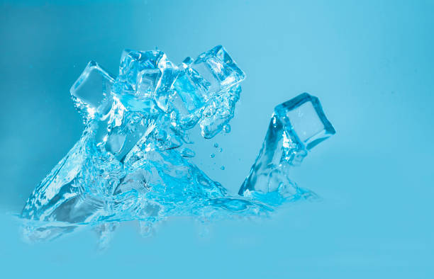 istock ice cubes with water splashing on blue background 1336480594