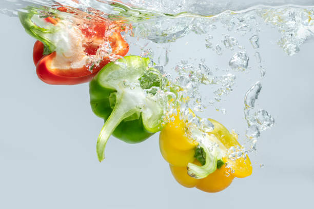 istock Sliced bell pepper splashes into the water. 1336480614