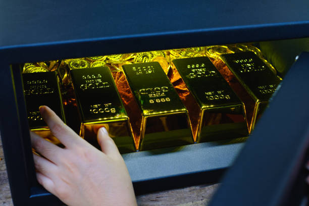 istock Hand open electronics steel safe box full of coins stack and gold bar 1336480979