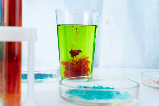 istock Manipulations with laboratory glass chemical containers on table 1336481030