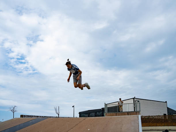 istock Young skaters doing acrobatic skating on the public skating rink 1336481301