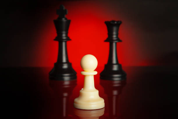 istock Chess pieces on dark background with red backlight close up 1336483233