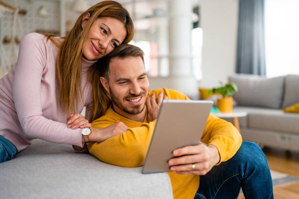 istock Happy couple spending time with tablet at home 1336485424