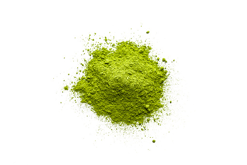 Overhead view of Matcha tea powder heap isolated on white background. High resolution 42Mp studio digital capture taken with Sony A7rII and Sony FE 90mm f2.8 macro G OSS lens
