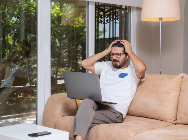 istock Freelance businessman working on his laptop at home with a sad expression 1336485771