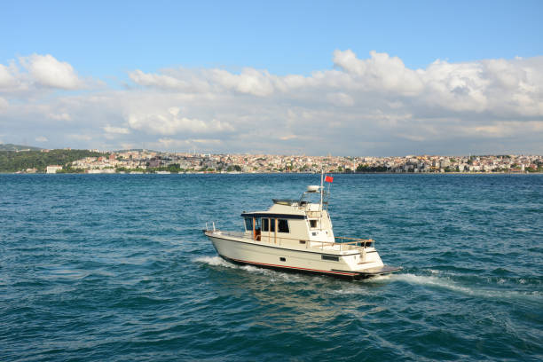 yacht in the blue sea under blue sky with white clouds in Istanbul