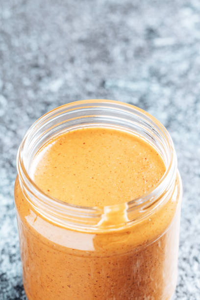 istock Crunchy peanut butter in a glass jar. 1336486886