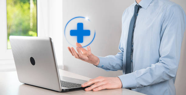 istock Businessman hold virtual plus medical network connection icons. Covid-19 pandemic develop people awareness and spread attention on their healthcare. 1336488278