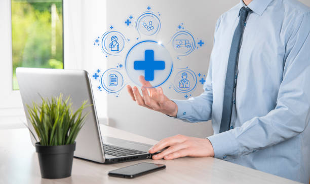 istock Businessman hold virtual plus medical network connection icons. Covid-19 pandemic develop people awareness and spread attention on their healthcare.Doctor,document,medicine,ambulance,patient icon. 1336488281