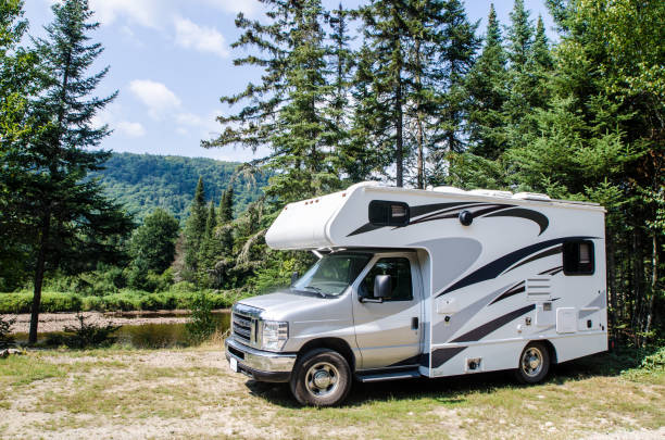 istock Motorhome parked in forest besides a river 1336489759