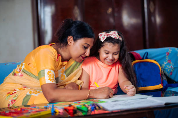 istock Mother Helping Her Daughter While Studying at home. 1336490856
