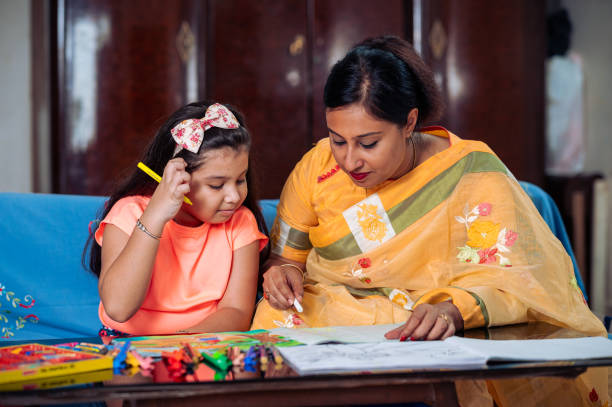 istock Mother Helping Her Daughter While Studying at home. 1336490881