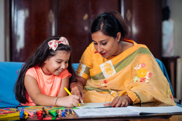 istock Mother Helping Her Daughter While Studying at home. 1336490897