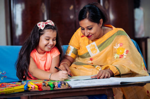 istock Mother Helping Her Daughter While Studying at home. 1336490898