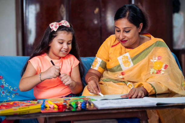 istock Mother Helping Her Daughter While Studying at home. 1336490899