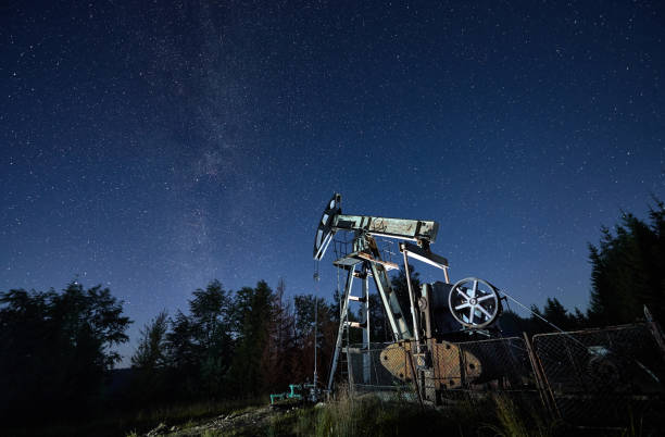 istock Night operation of petroleum rocking pump under starry sky. 1336491091