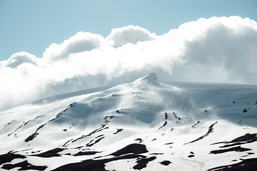 Snæfellsjökull Glacier and Snow Capped Strato Volcano - Snaefellsjokull Mountain Peak under sunny summer skyscape. Snæfellsjökull Volcano, Western part of the Snæfellsnes - Snaefellsness Peninsula, Iceland, Nordic Countries, Northern Europe, Europe.