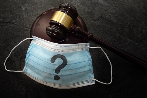 Court legal gavel and facemask with question mark -- Coronavirus mask concept