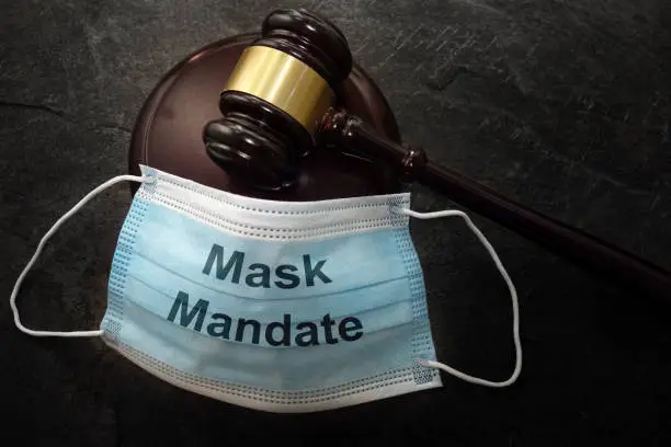 Photo of Court legal gavel and Mask Mandate facemask